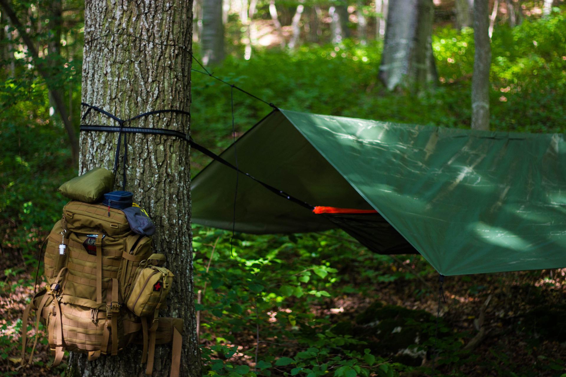 Camping and tent stay in forest trekking backpack