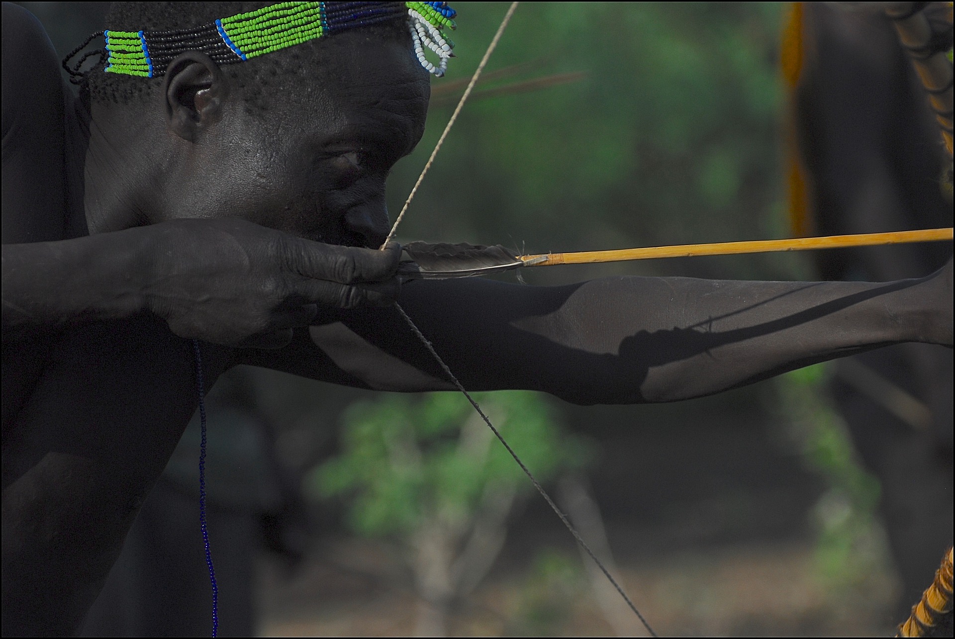 Image of a Caveman hunting food inside the forest to represnt the core nature of the event