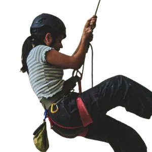 Certified outdoor guide wearing a helmet and harness while performing a rope activity during an adventure trekking program